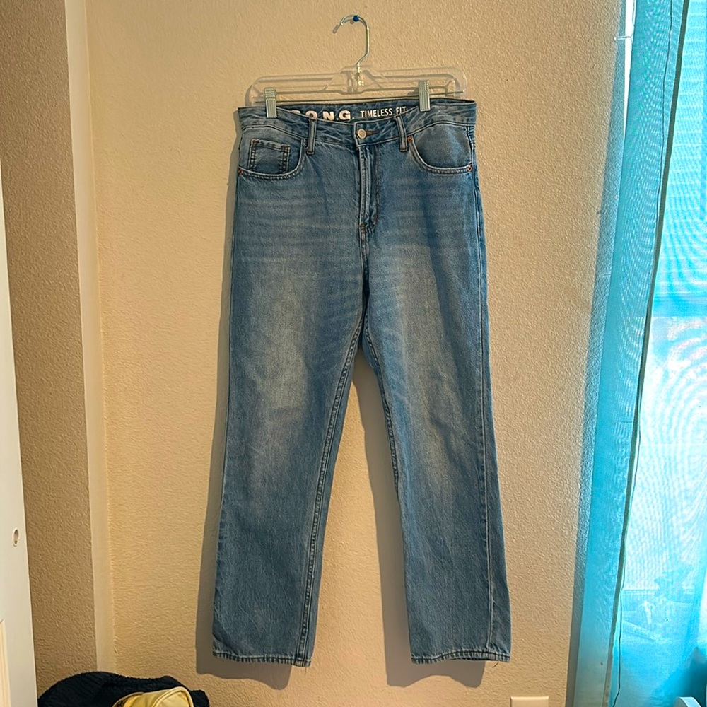light blue mom jeans with garden embroidery on the back pockets